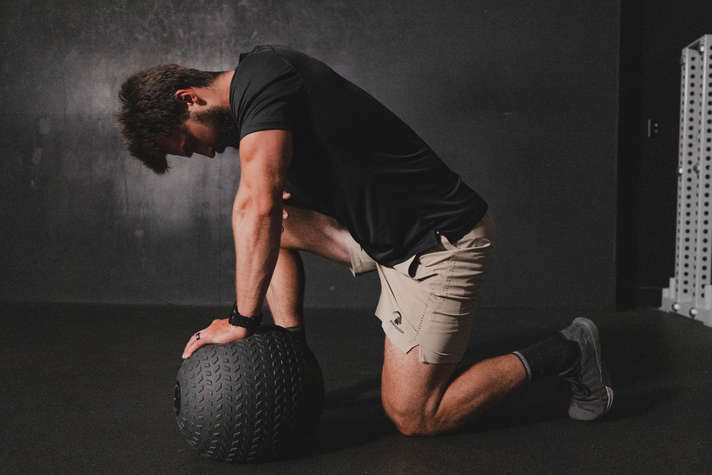 Man exercising with a medicine ball on a dark background
