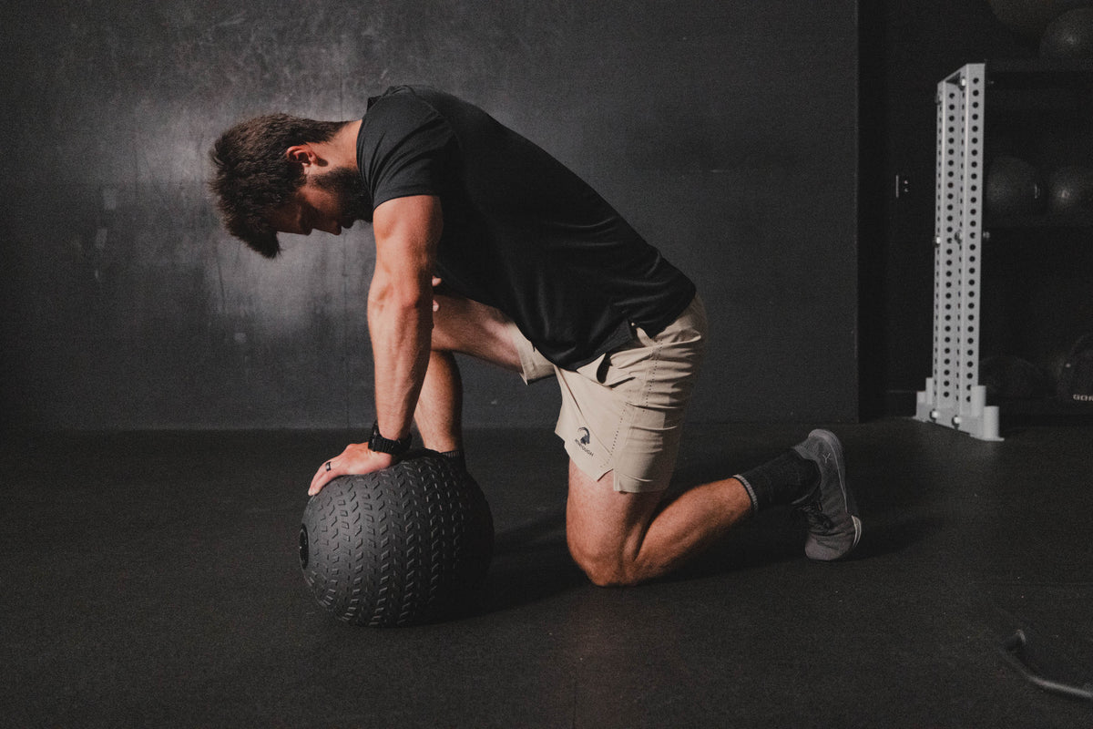 Man exercising with a medicine ball in a gym setting