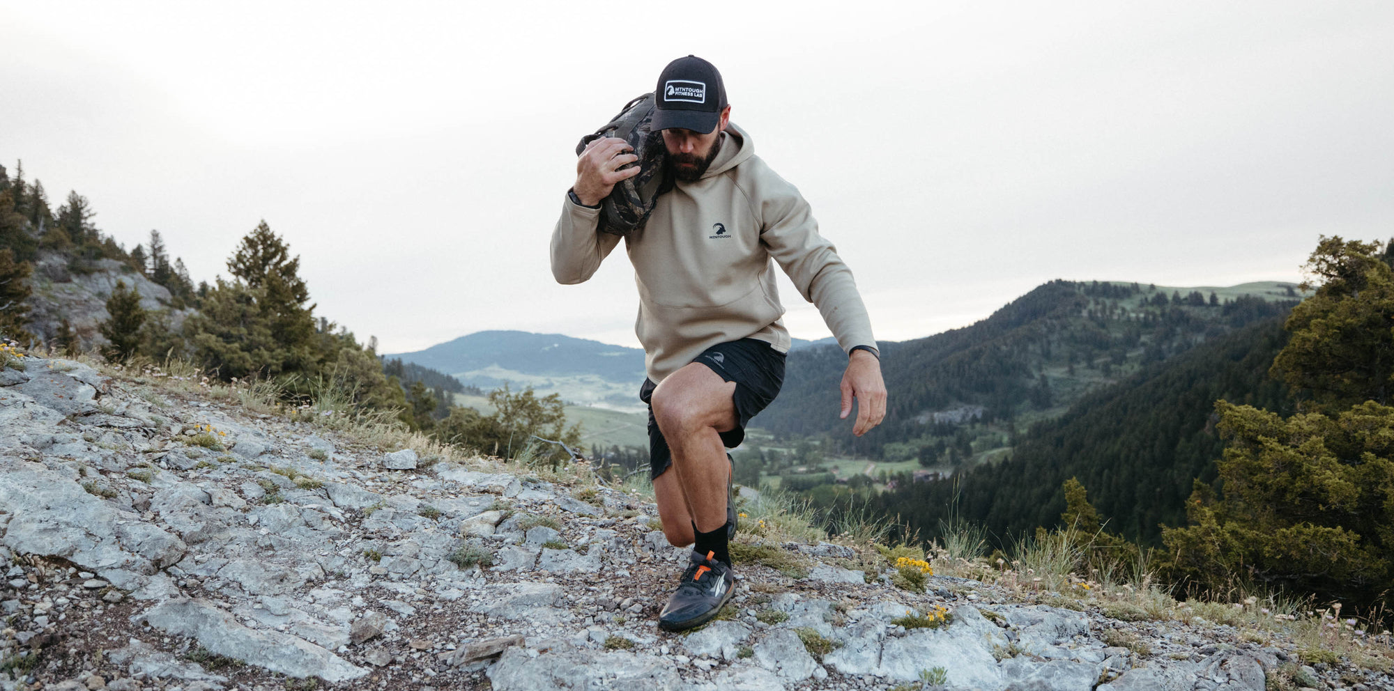 Person hiking on a mountain trail with scenic view