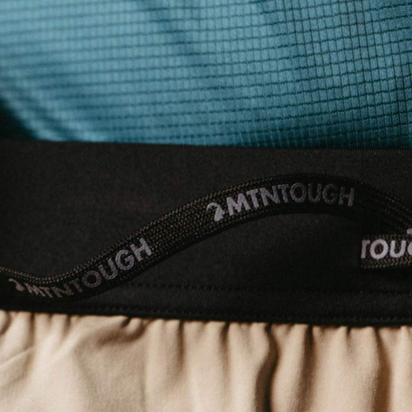Close-up of a product with '2MTNTOUGH' branding on a textured background.