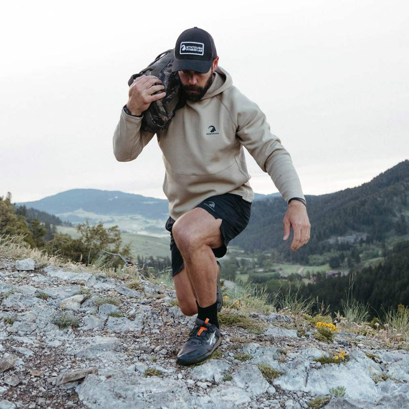 Man hiking on a mountain trail with a backpack