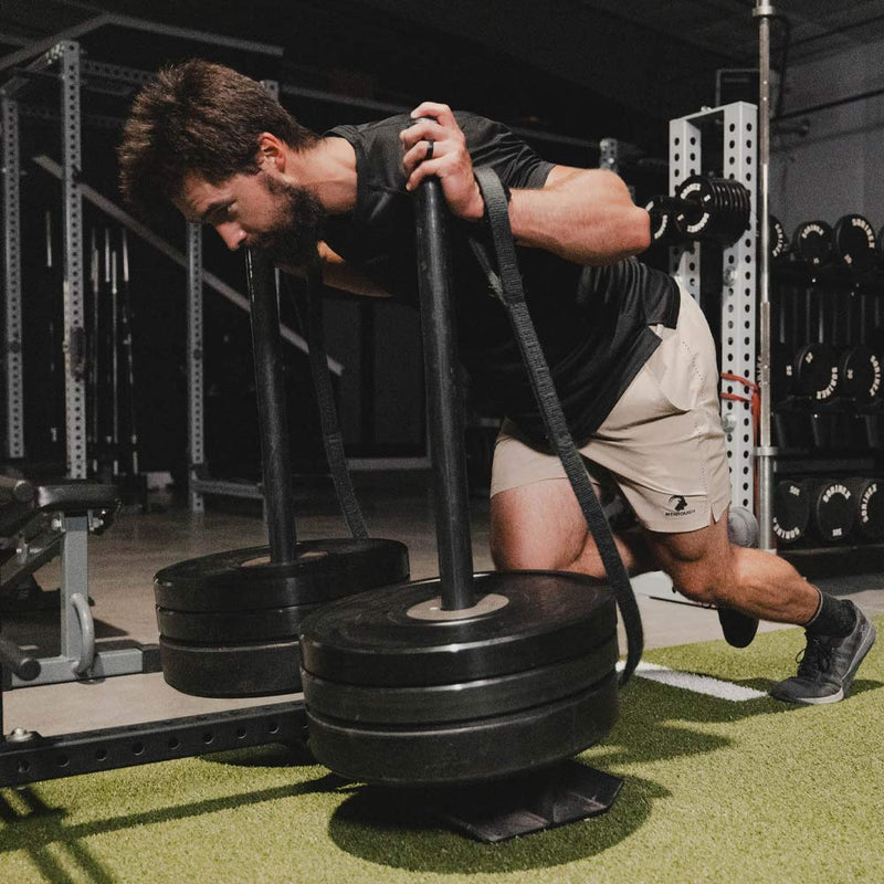 Man lifting a heavy weight stack in a gym setting